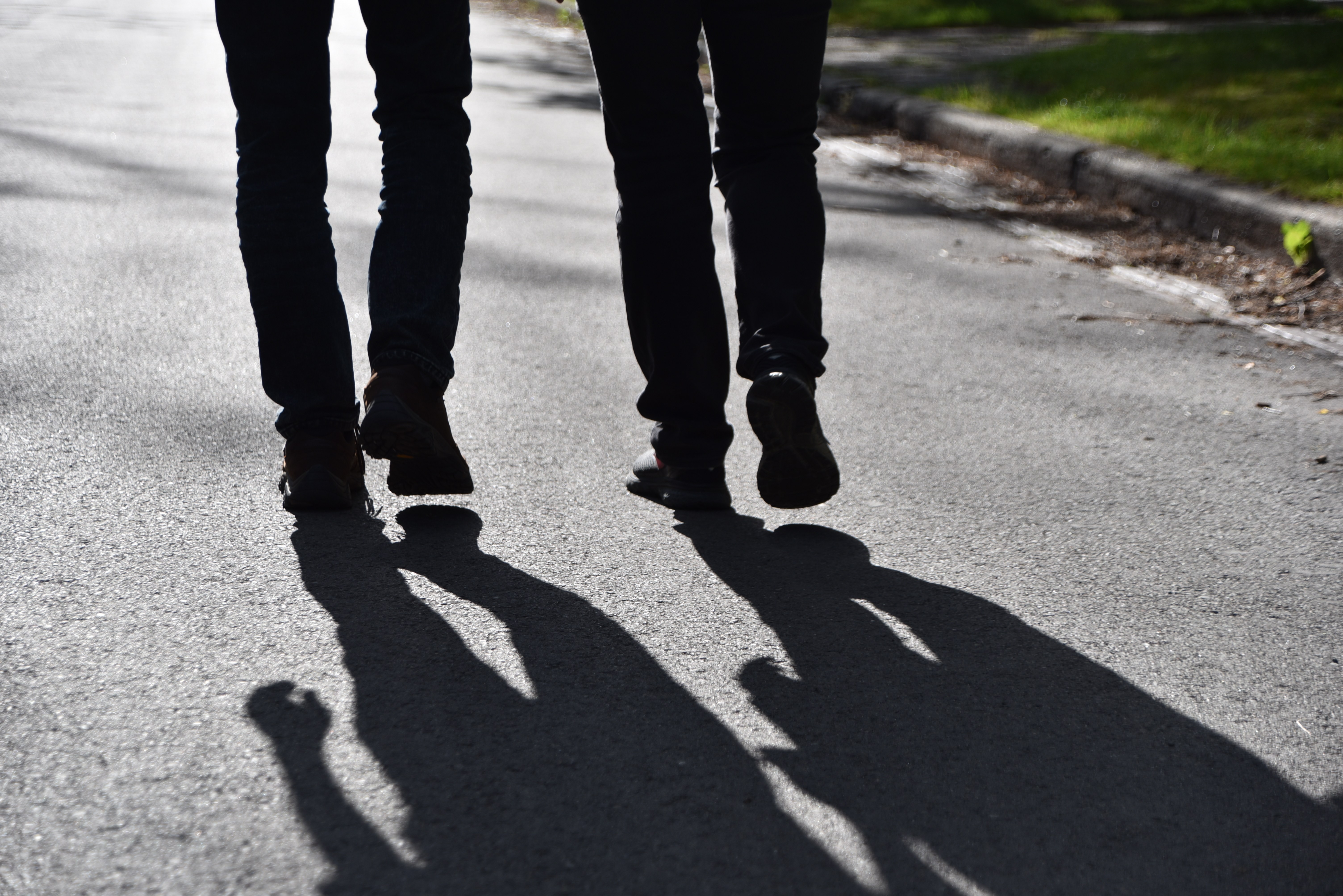 Two pair of feet walking side-by-side showing Jamie Greene with another person as a coach or pastor